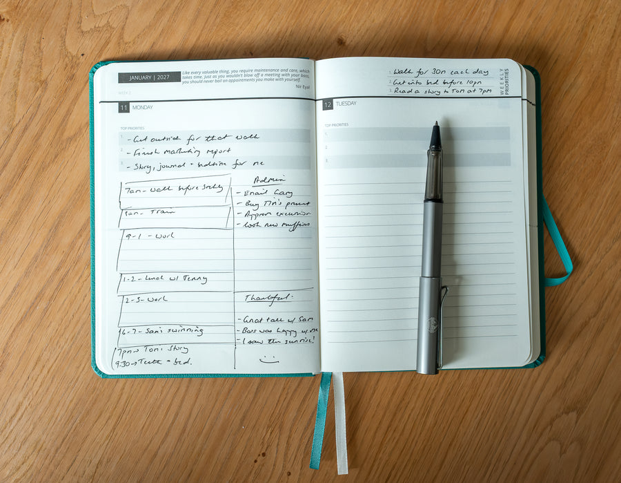 This image shows a side by side comparison of the daily page of the 2027 Mental Fitness Diary. The left page is filled in with goals and timeblocks, the right page is blank. 